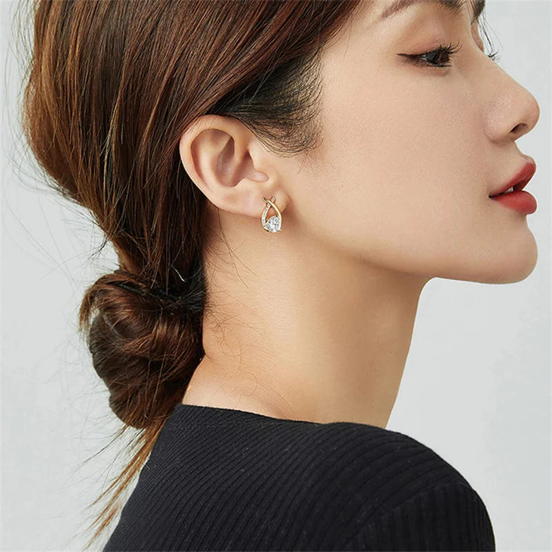 SKEDS cross stud earrings by Simples Market, gold-tone with clear crystal teardrop
