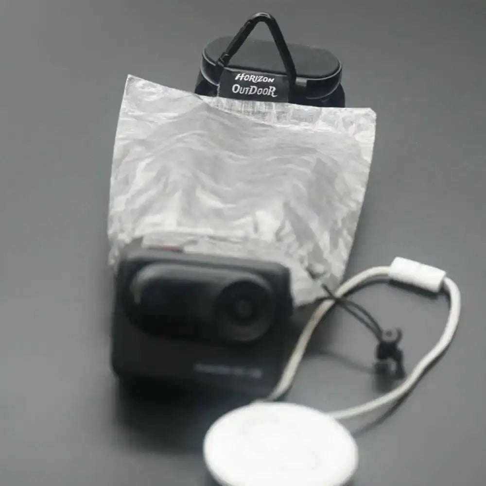 Stashlite lantern diffuser in ultralight Dyneema DCF stuff sack; silver Cuben Fiber bag with Horizon Outdoor tag.