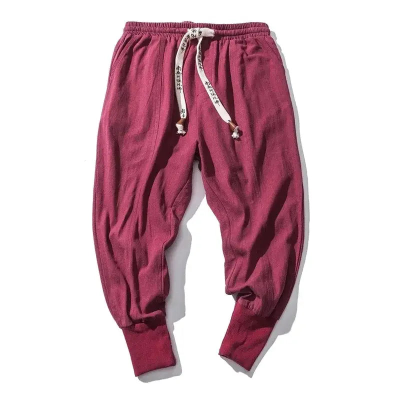 Men's cotton-linen baggy drop-crotch pants in burgundy with white drawstring and cuffed ankles