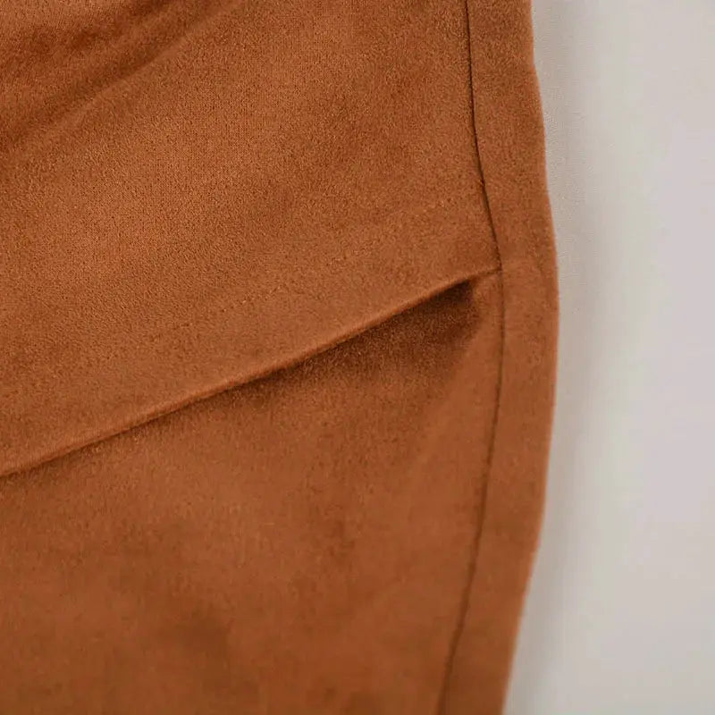 Suede mini skirt close-up in brown with seam detail and soft texture