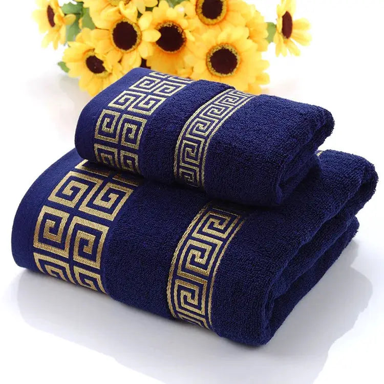 Two navy blue cotton towels set, bath and hand towel, with gold Greek key border embroidery.