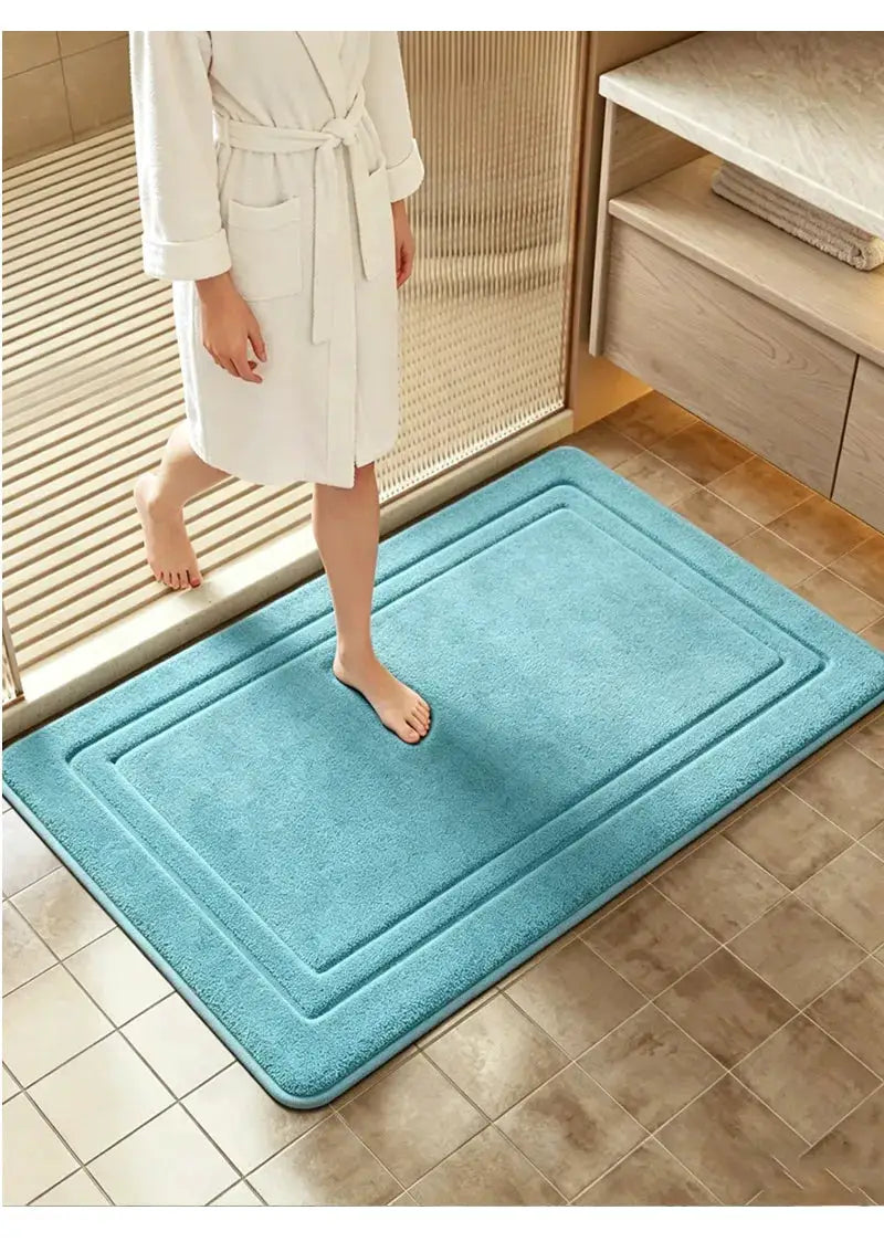 Blue plush bathroom rug with soft texture for stepping from the shower