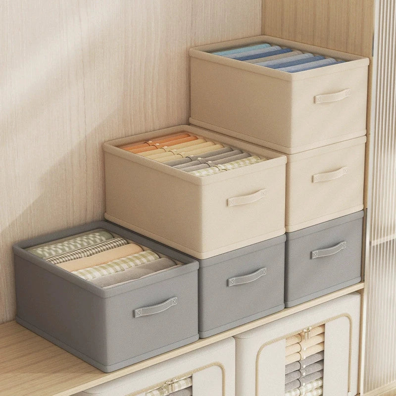 Clothes organizer fabric storage boxes, six beige and gray, stackable on wardrobe shelf with handles.