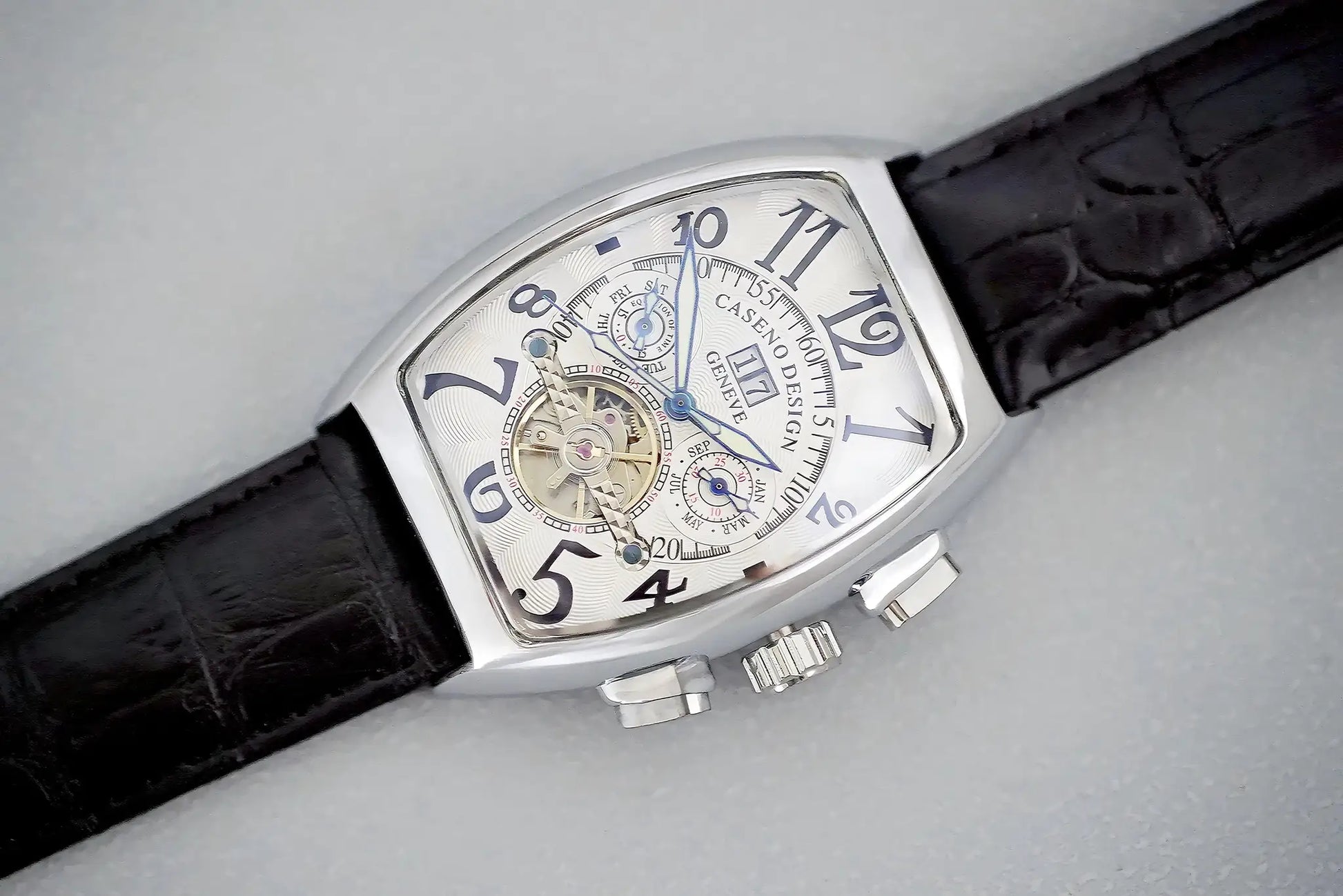 Men's automatic skeleton tourbillon watch with silver tonneau case and blue hands