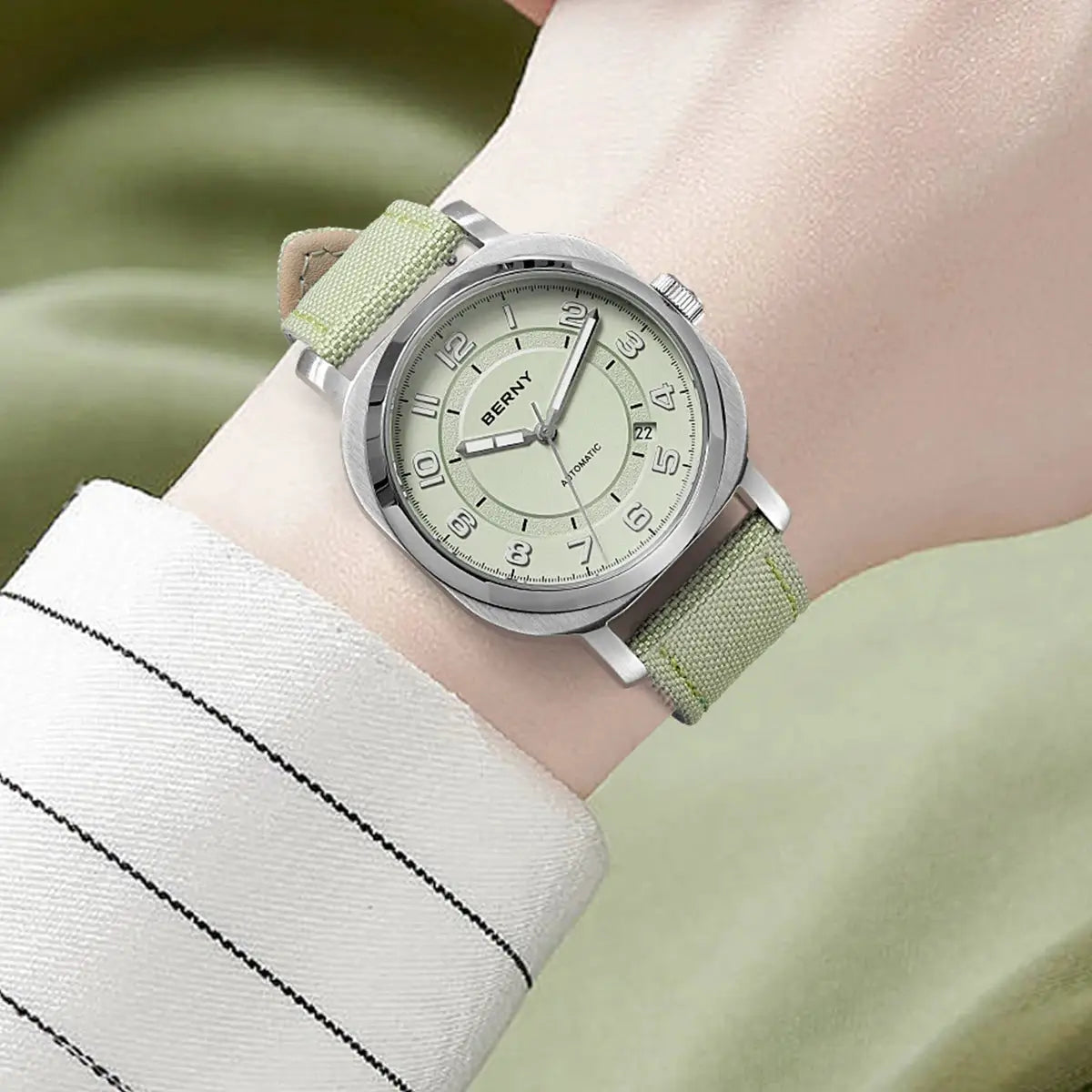 BERNY women's mechanical watch with green fabric strap, silver case, and luminous dial