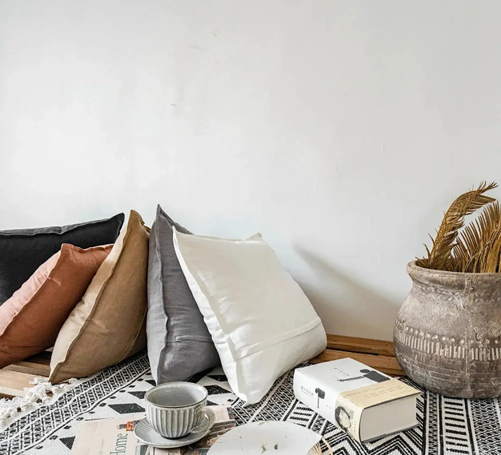 Decorative ramie cushion covers, boho farmhouse style, 5 assorted color pillowcases on a wooden bench