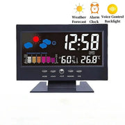 Black digital weather station clock with LCD display showing time, temperature, humidity, date and weather icons.