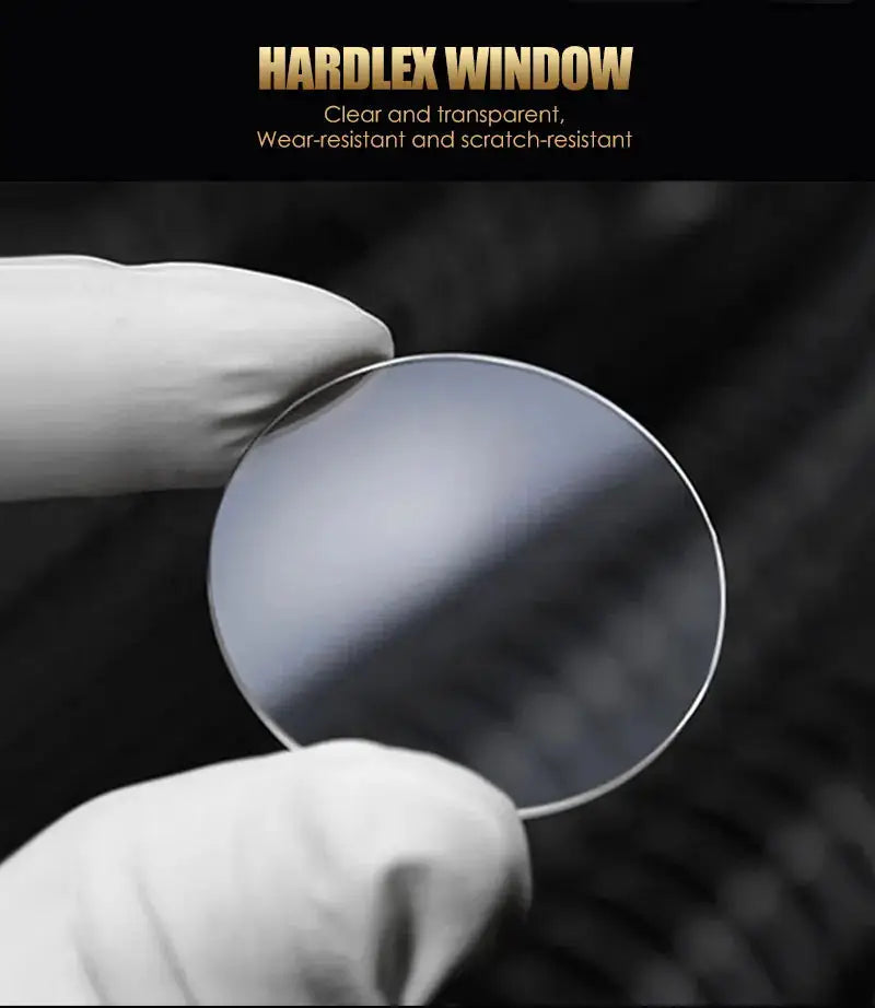 Watch glass lens sample with hardlex window; circular, clear and scratch-resistant, held by gloved hands