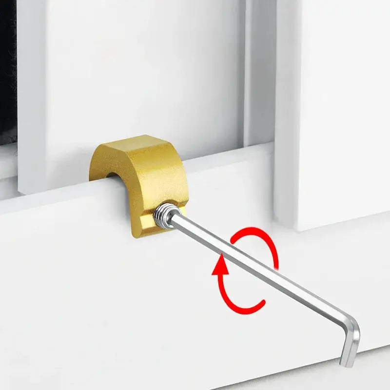 Aluminum window lock stopper in gold finish, mounted on a white window frame with a silver locking rod