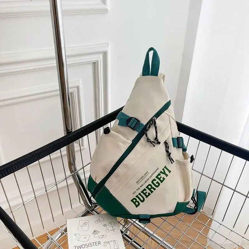 New Y2k nylon crossbody bag by Simples Market; beige with green straps and buckles.