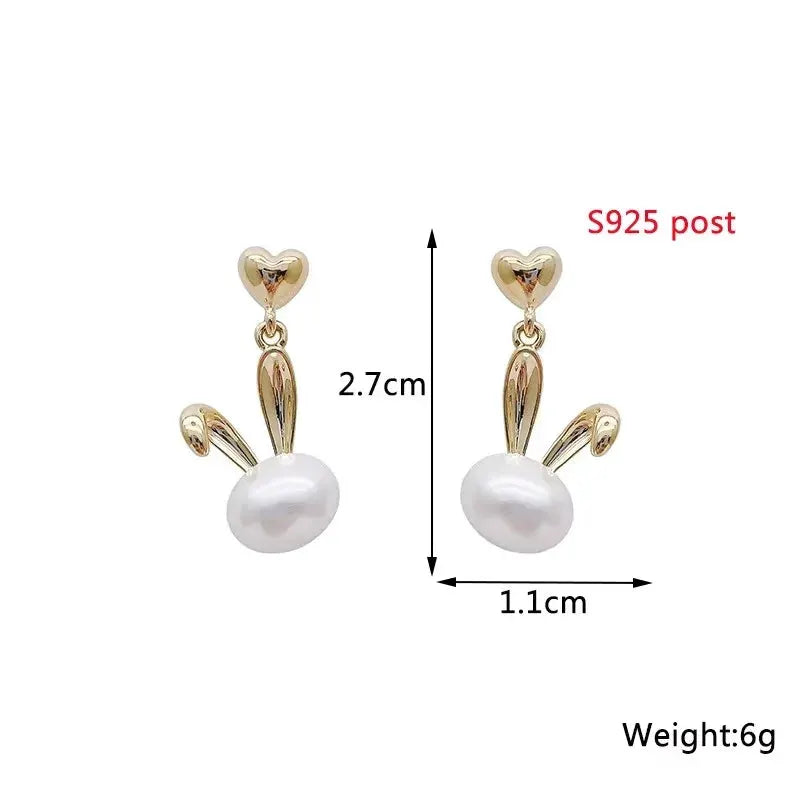 Pair of white dangle earrings with gold-tone heart studs and pearl drops, S925 post