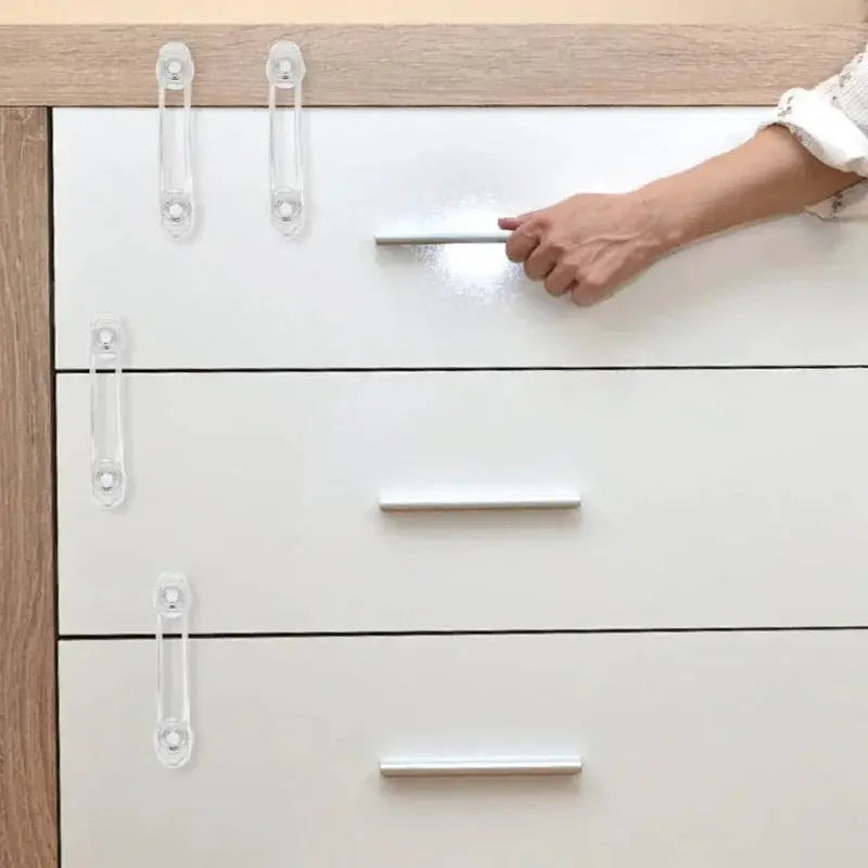 Multi-functional child safety lock set with five clear straps on white drawers for home safety