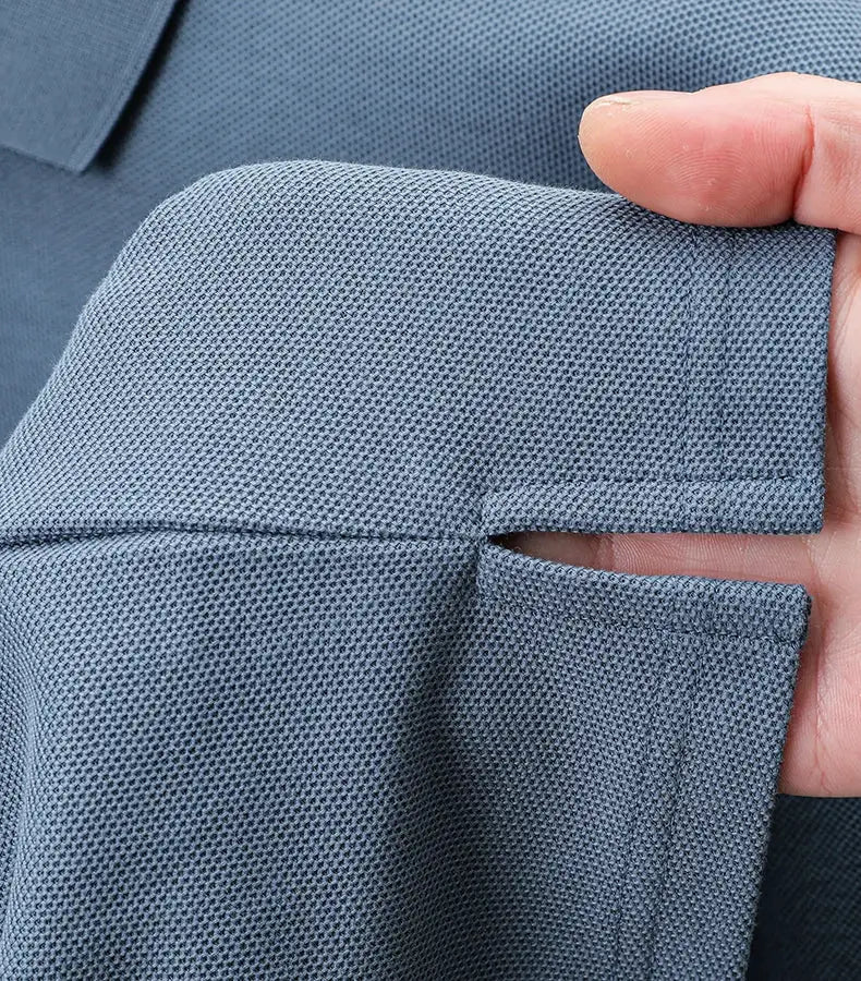 Blue 100% cotton polo shirt with folded sleeve cuff close-up