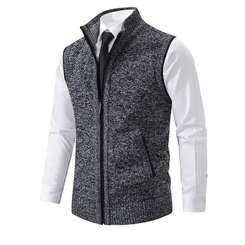 Men's knitted sleeveless zip-up sweater vest in heather gray with stand collar, worn over white dress shirt and tie