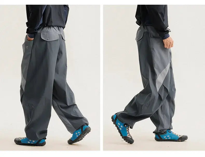 Men's gray cargo track pants with ultra loose wide-leg fit and splice side panels in quick-dry fabric