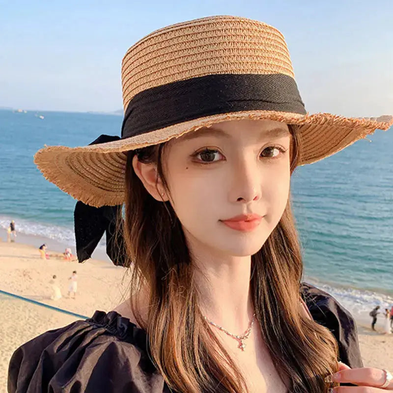 Korean bow straw hat for women with wide brim and black ribbon, beach-ready Panama style