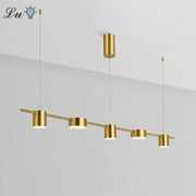 Modern LED linear pendant chandelier with five gold cylindrical lights on a bar, suspended from ceiling