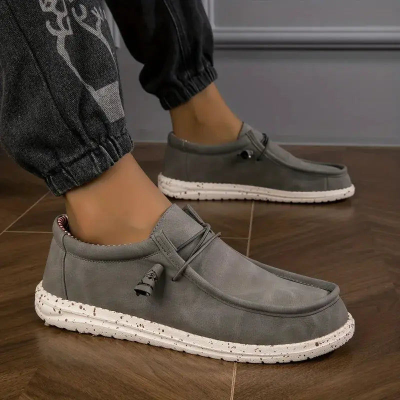 Pair of men's grey slip-on loafers with white speckled soles