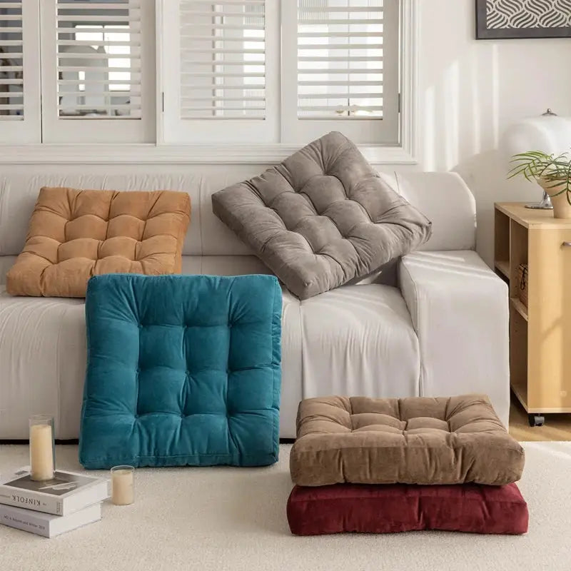 Floor pillows: five tufted square cushions in teal, beige, taupe, brown, and burgundy for seating.
