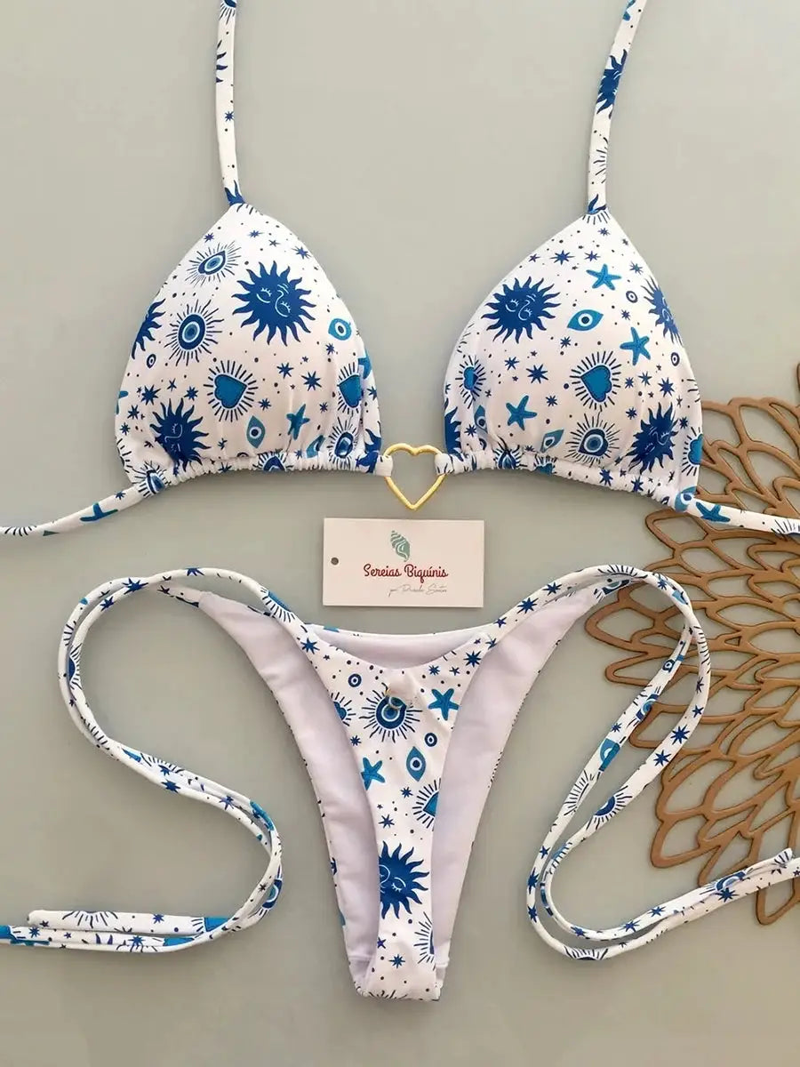 Simples Market two-piece micro bikini set in white with blue celestial print, halter top and thong bottoms