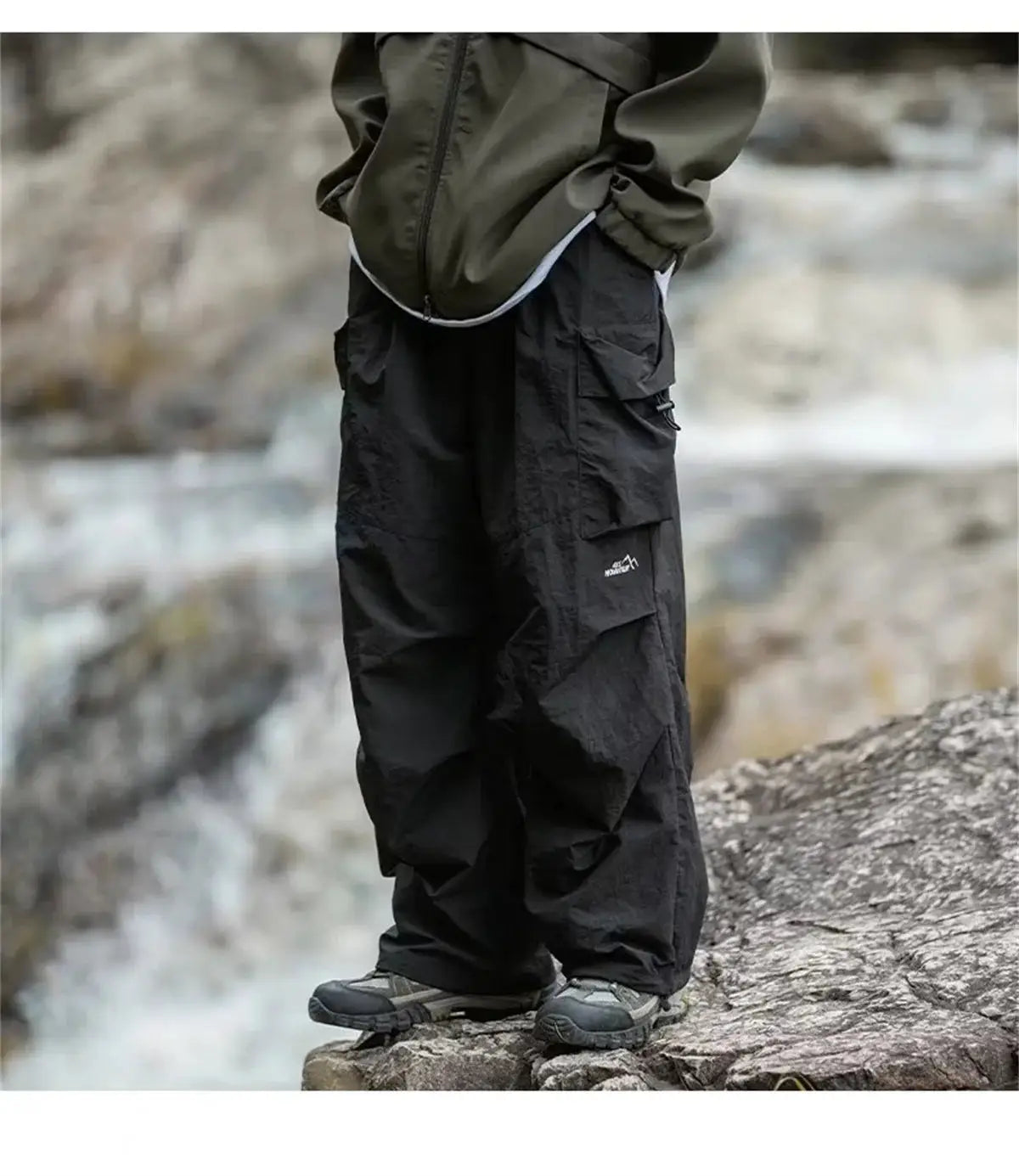 Men's black waterproof cargo mountaineering pants with multiple pockets