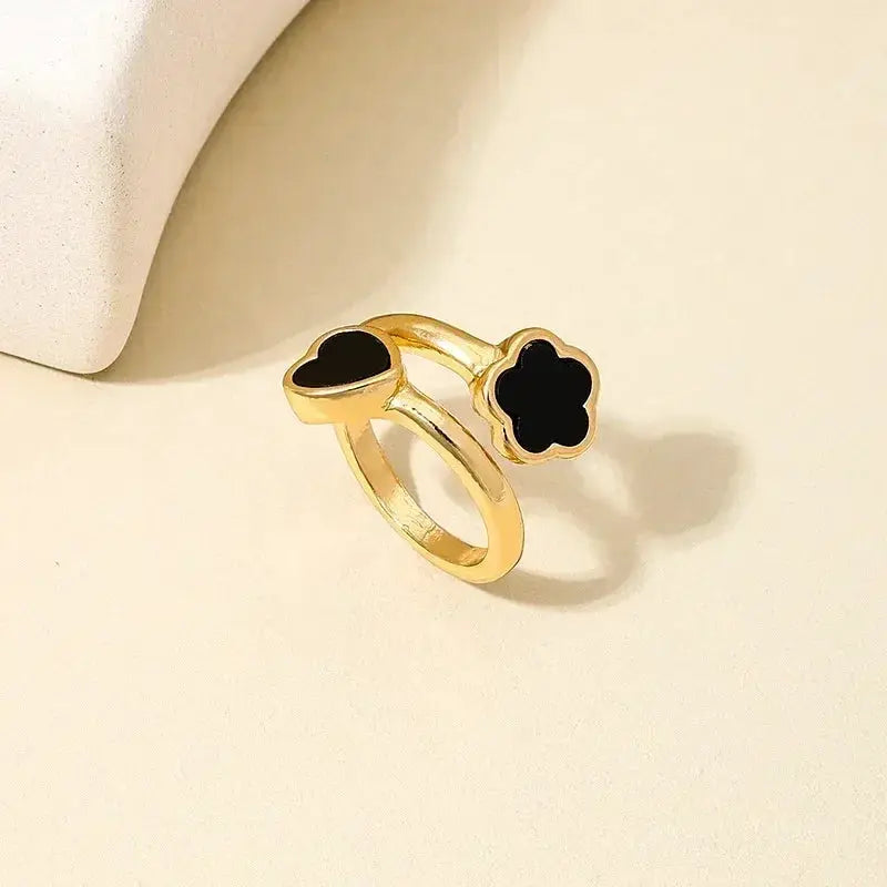 Exaggeration Punk Ring Set for Women in gold-tone metal, adjustable rings with black enamel heart and clover designs.