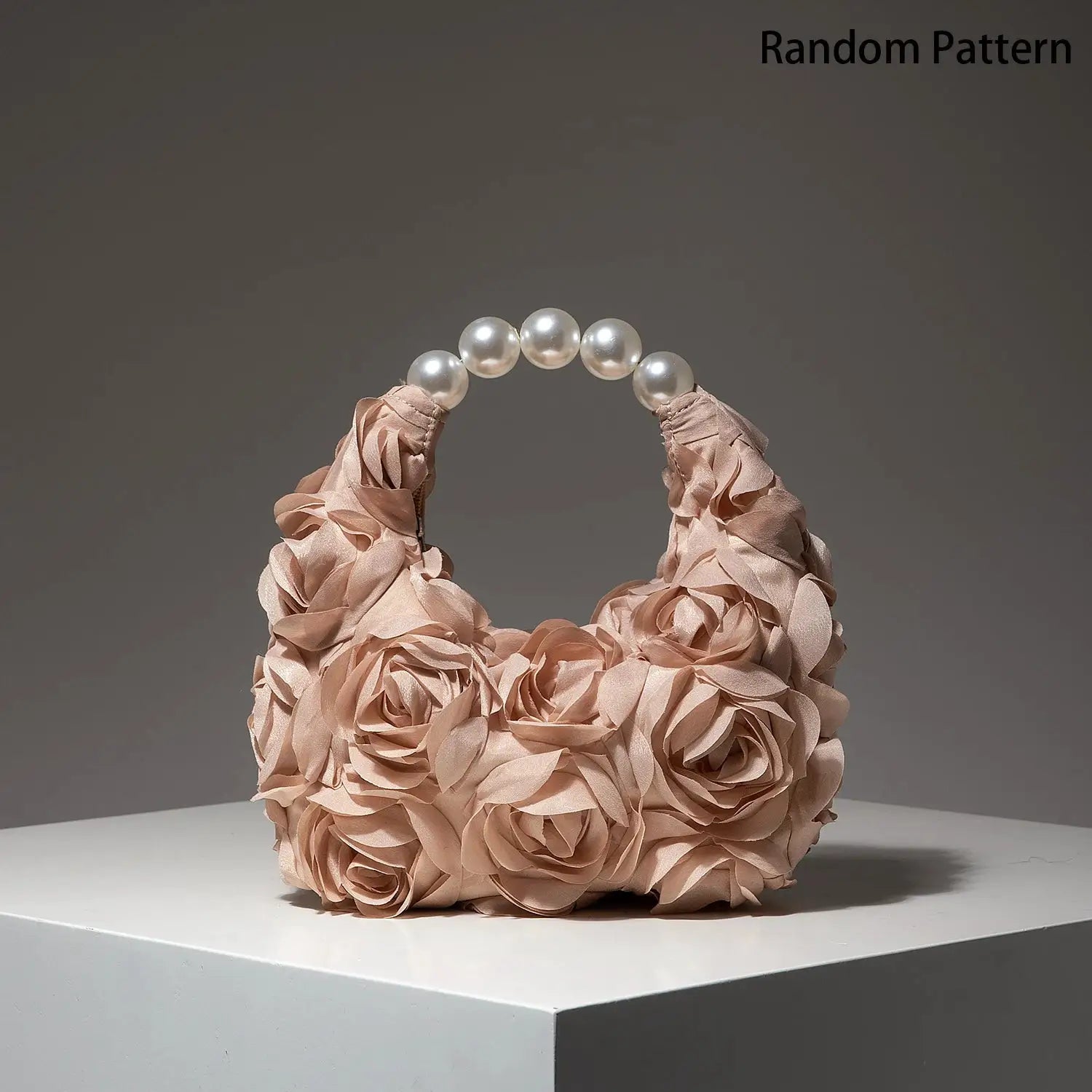 Pearl-beaded handle bag in blush with fabric rose detailing by Simples Market