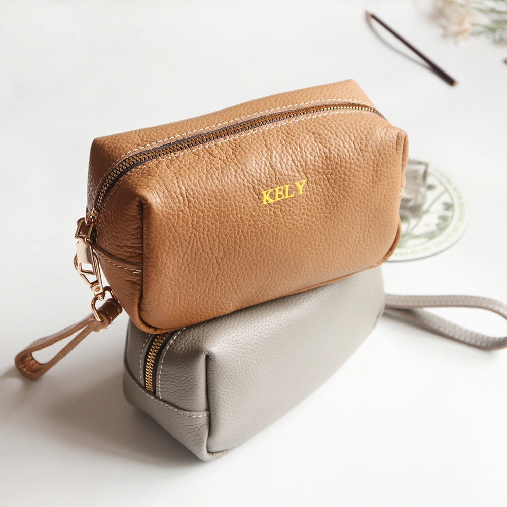 Two-tone genuine leather card holders in tan and gray; one with gold engraving KELY.