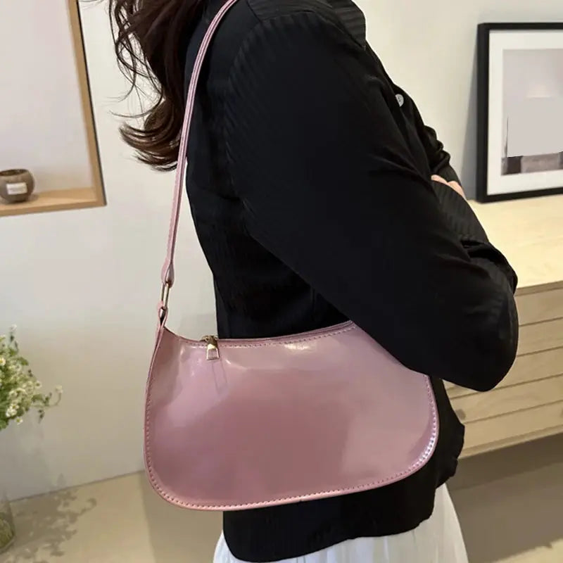 Retro PU leather shoulder bag in pastel pink by Simples Market; glossy finish, zipper top, single strap.