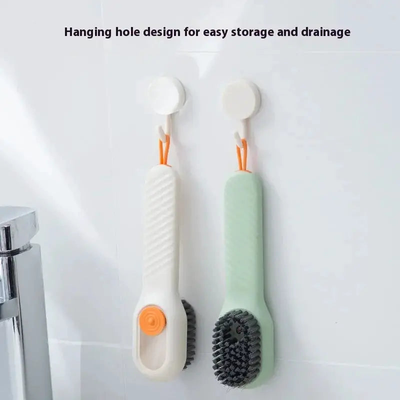 Two shoes brush cleaning tools with soft bristles; white and mint green handles, wall-mounted