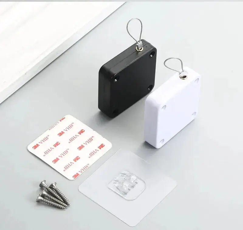 Automatic drawstring door closer kit by Simples Market, black and white plastic housings with screws and 3M VHB pads