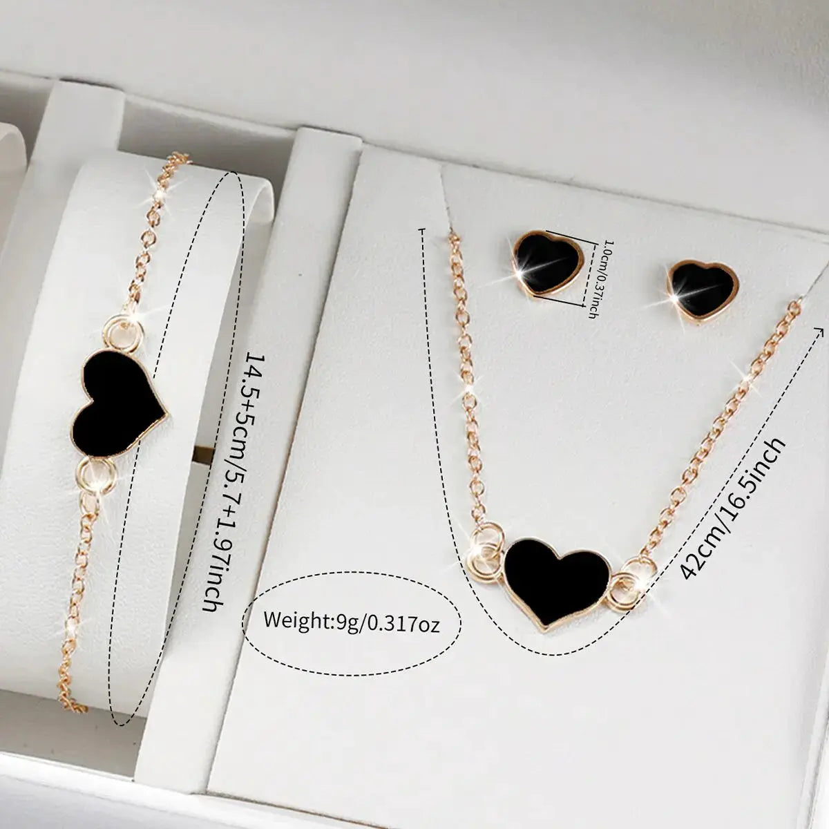 Heart pendant jewelry set in rose gold with black enamel, includes necklace, bracelet and heart stud earrings