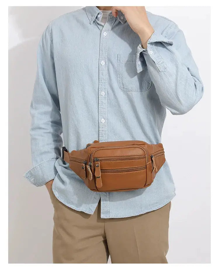 Men's genuine leather fanny pack in brown with multiple zip pockets worn at the waist.
