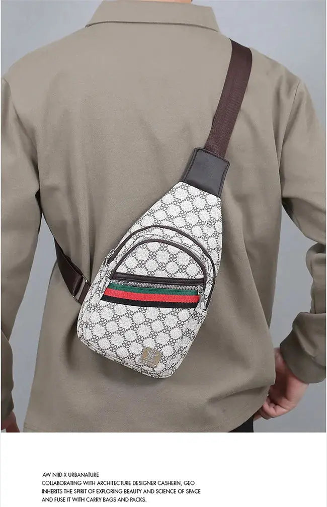 Men's crossbody messenger bag in beige patterned fabric with brown strap and front zip pocket with green-red stripe.