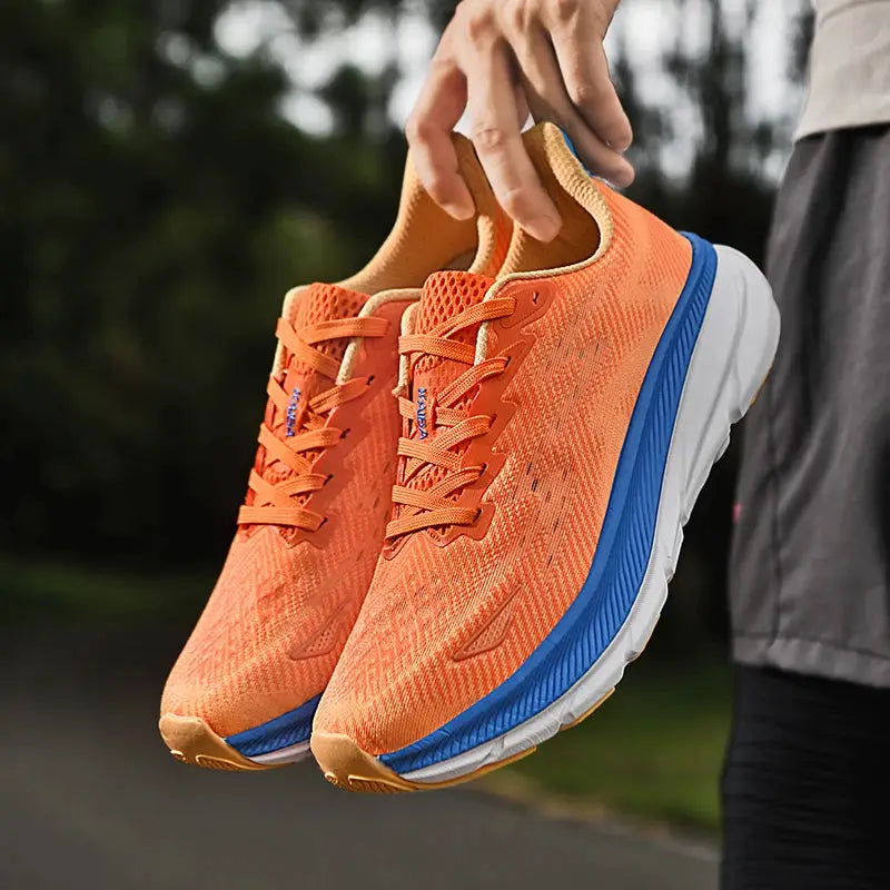 Men's running shoes by Simples Market in orange mesh with blue sole and cushioned white midsole