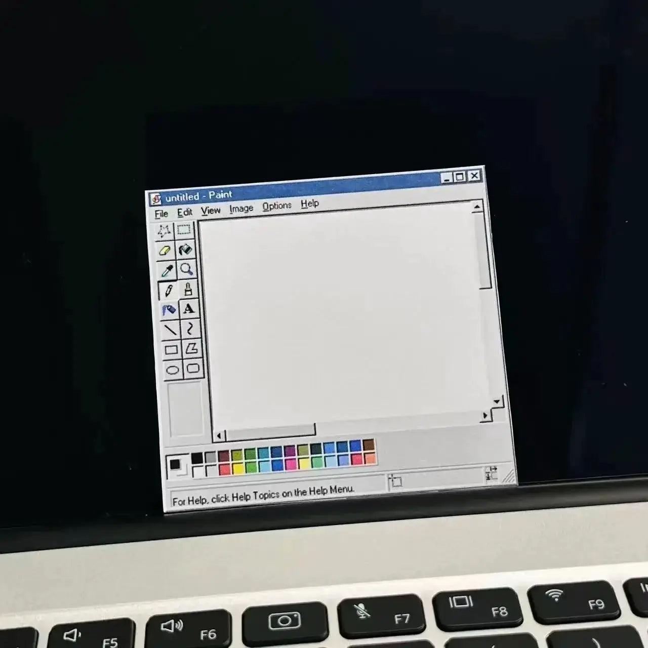 Notepad by Simples Market, 50-page retro computer-drawing-tools pattern with minimalist color scheme on laptop screen