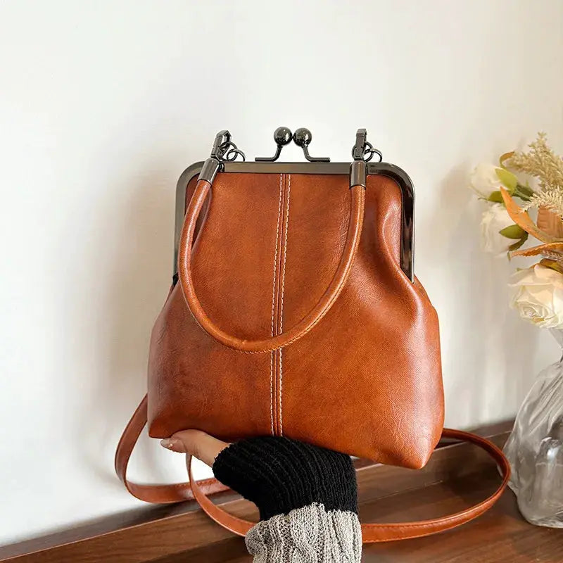 Vintage style women's brown PU leather handbag with metal frame clasp and crossbody strap