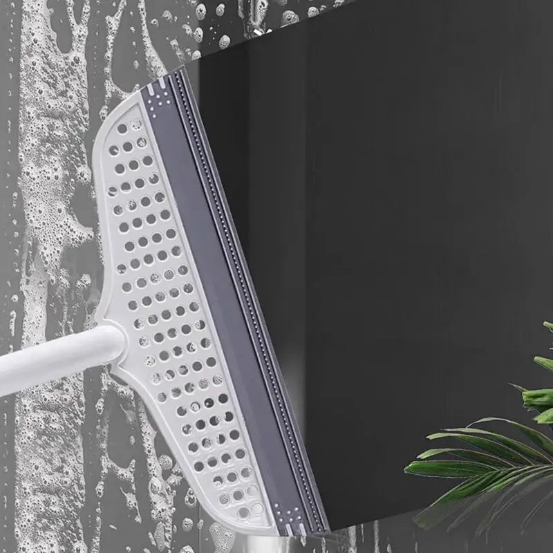 Silicone scraper broom squeegee with white and purple head on a pole for bathroom floor and window cleaning.