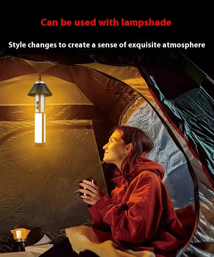 Rechargeable camping tent lamp with white body and black cap, hanging inside a tent by Simples Market