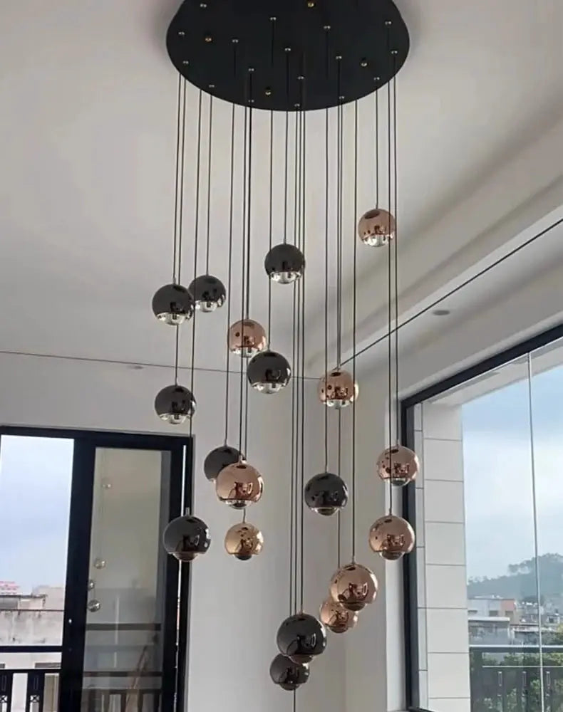 Modern pendant light with hanging black and rose-gold globe spheres from Simples Market