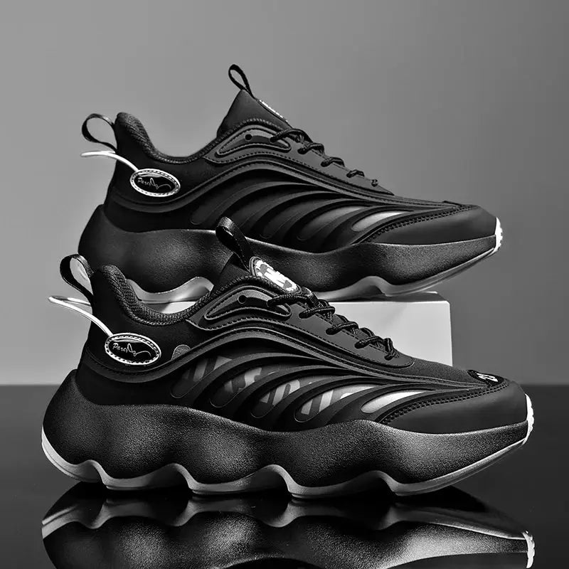 Men's black sneakers with wave panels and chunky sole, two shoes shown.