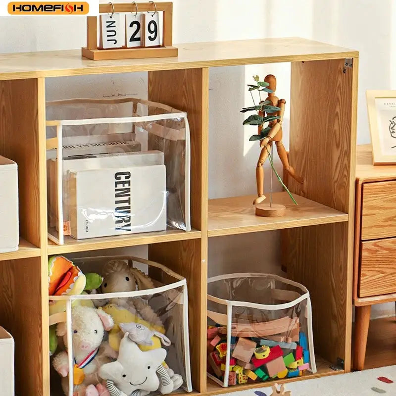 Homefish transparent storage baskets; three clear plastic bins on a wooden shelf holding plush toys and building blocks.
