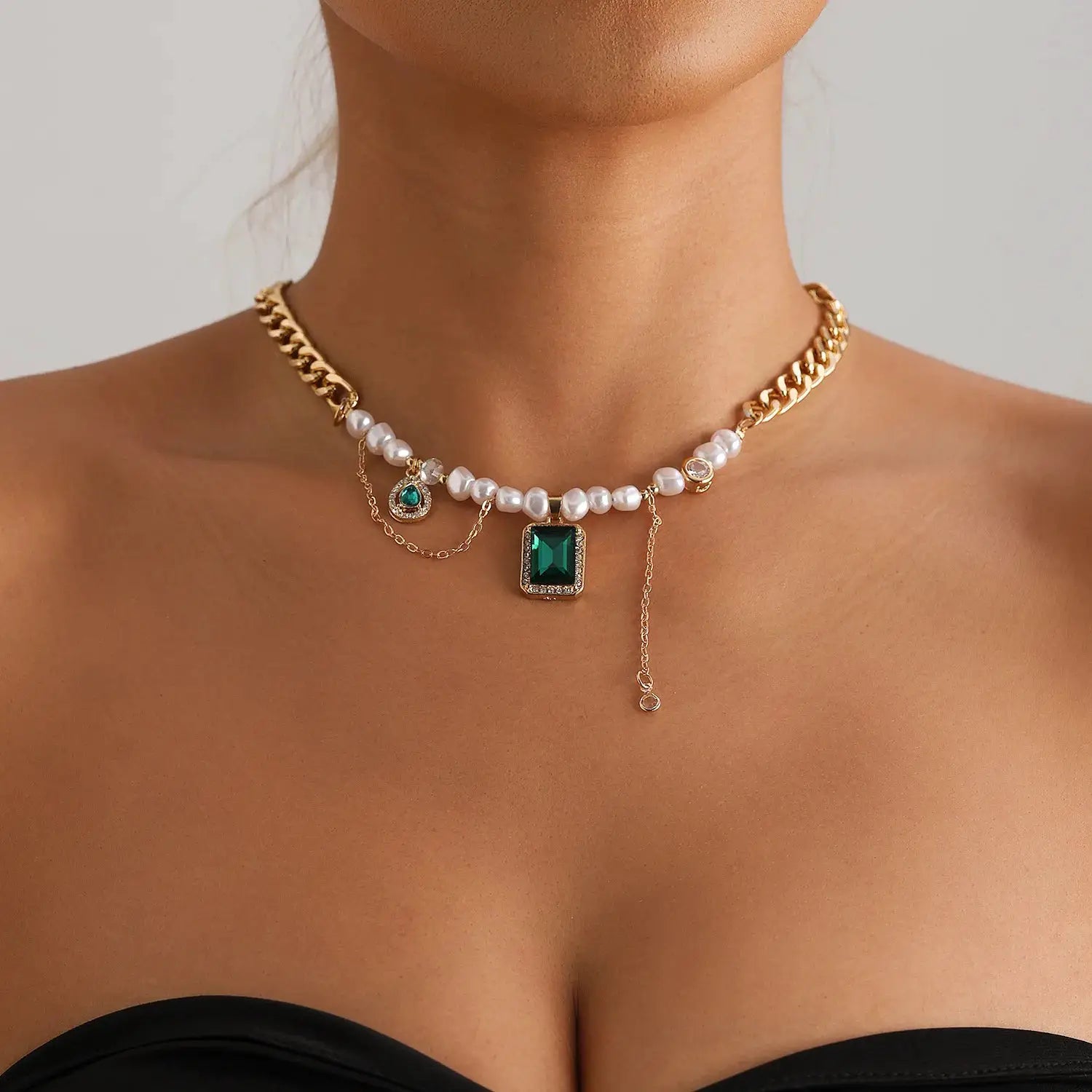 Y2K heart beaded necklace featuring white faux pearls, gold-tone chain, emerald square pendant, and heart-crystal charm