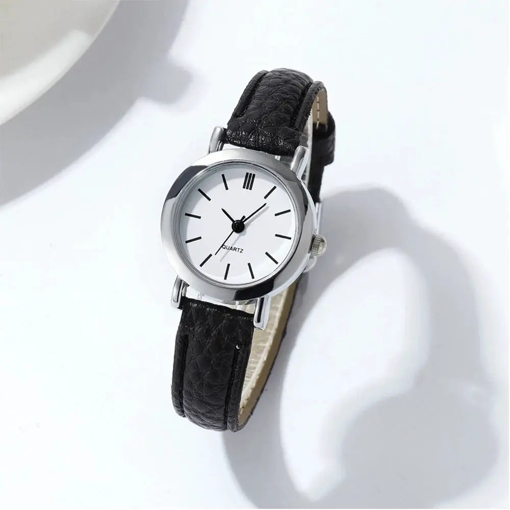 Women's wristwatch with white dial, black leather strap, silver case, quartz movement