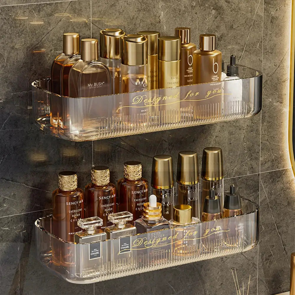 Two-tier clear acrylic bathroom storage rack with assorted perfume and skincare bottles