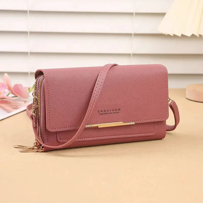 Simples Market women's mid-size pink faux leather wallet bag with convertible shoulder strap and coin pocket.