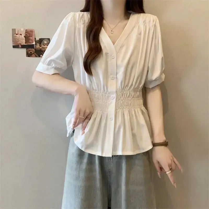 White smocked-waist blouse with short puff sleeves, V-neck and button-front