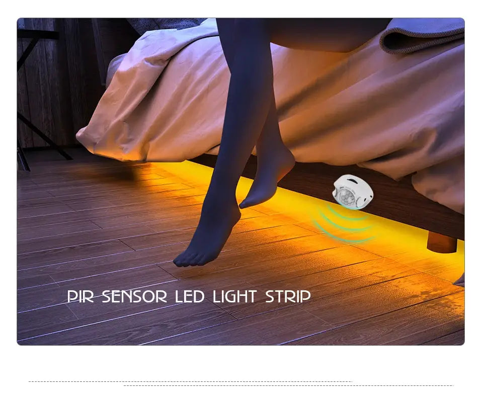 PIR sensor LED light strip under bed, motion-activated with warm orange glow along floor