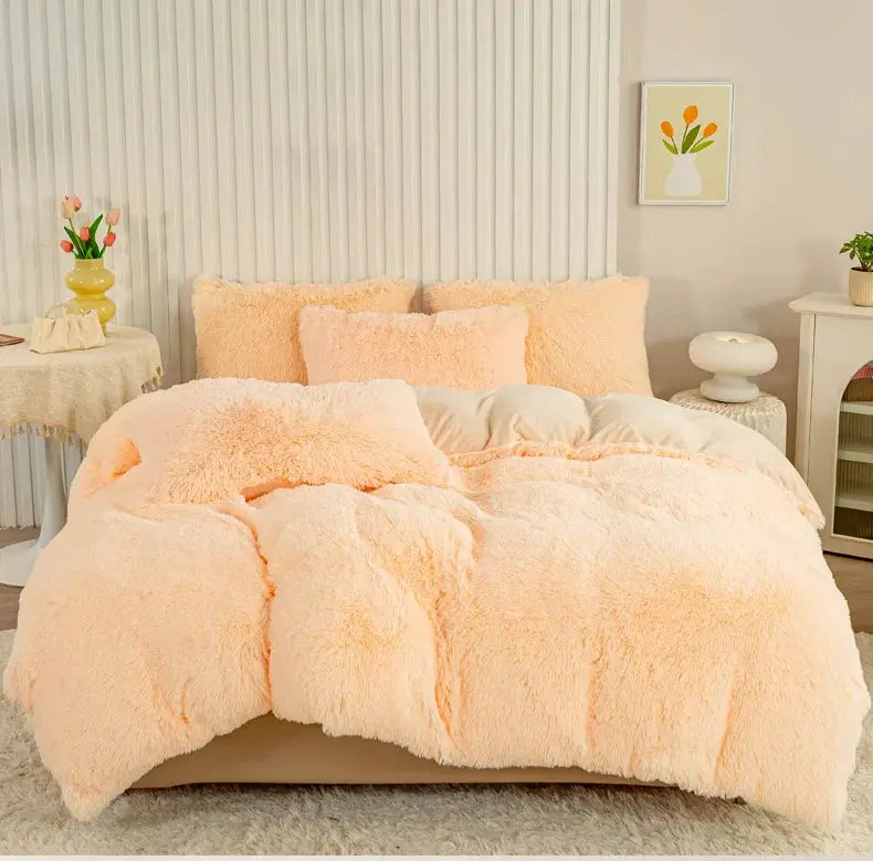 3-Piece plush peach duvet cover set with fluffy pillow shams on a bed