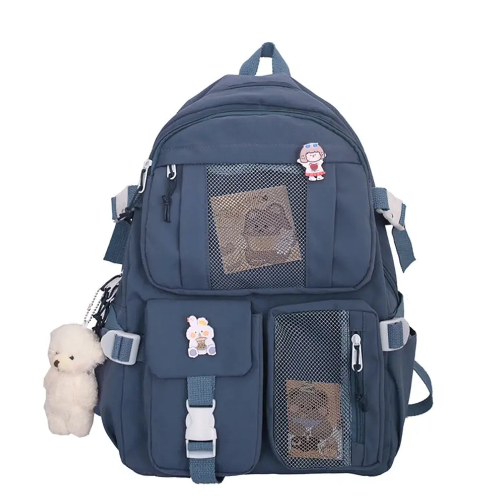 Navy blue nylon school backpack with multiple pockets, mesh panels, and teddy bear keychain